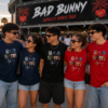 Grupo de amigos con camisetas unisex inspiradas en la discografía de Bad Bunny antes de un concierto. Diseño exclusivo disponible en MAITE CRAFTS.